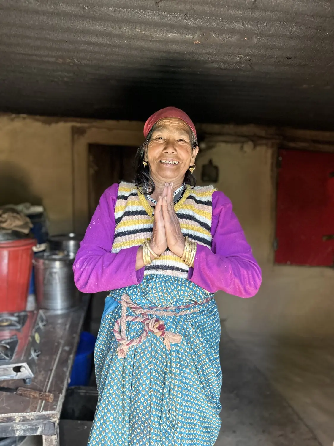 a local woman greeting guests in her kitchen