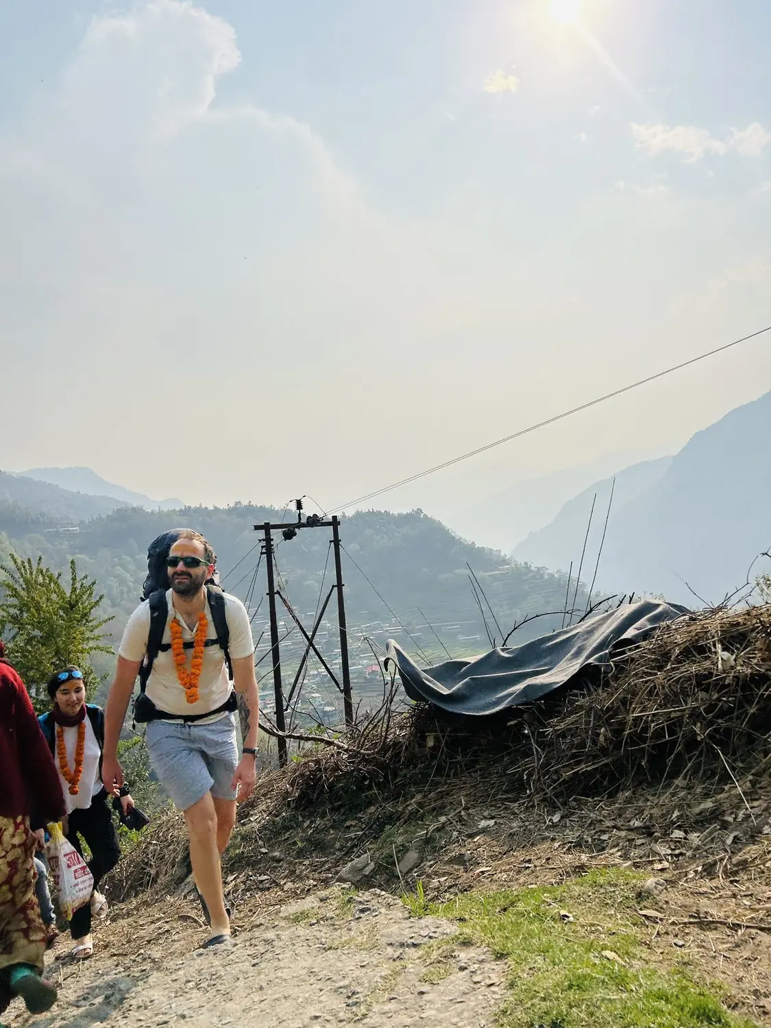 guests walking the mountain trail with the valley behind