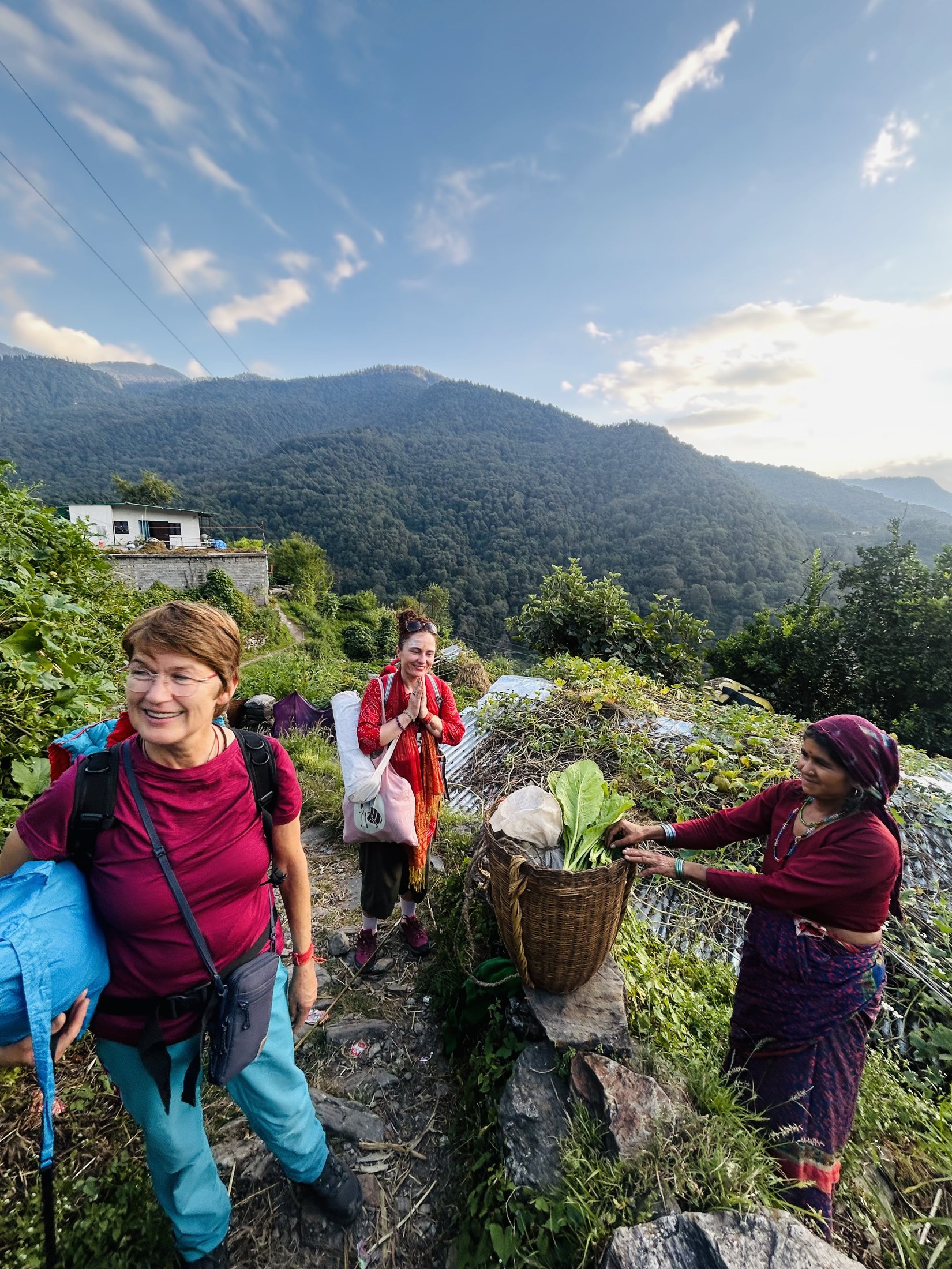 Guests sitting quietly with a local family in a mountain garden